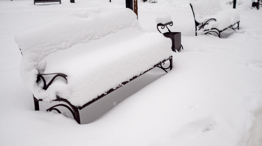 snow-covered wooden bench