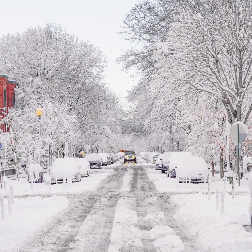 snow plowing street after blizzard